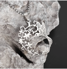 Load image into Gallery viewer, Humming Bird + blossom necklace Silver colour: Fun and Affordable. high quality Hypo allergic stainless steel.  Parts Made in China No shipping to US due to tarrifs